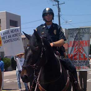 Mounted police at the San Diego Pride Parade cordon off an area for protesters